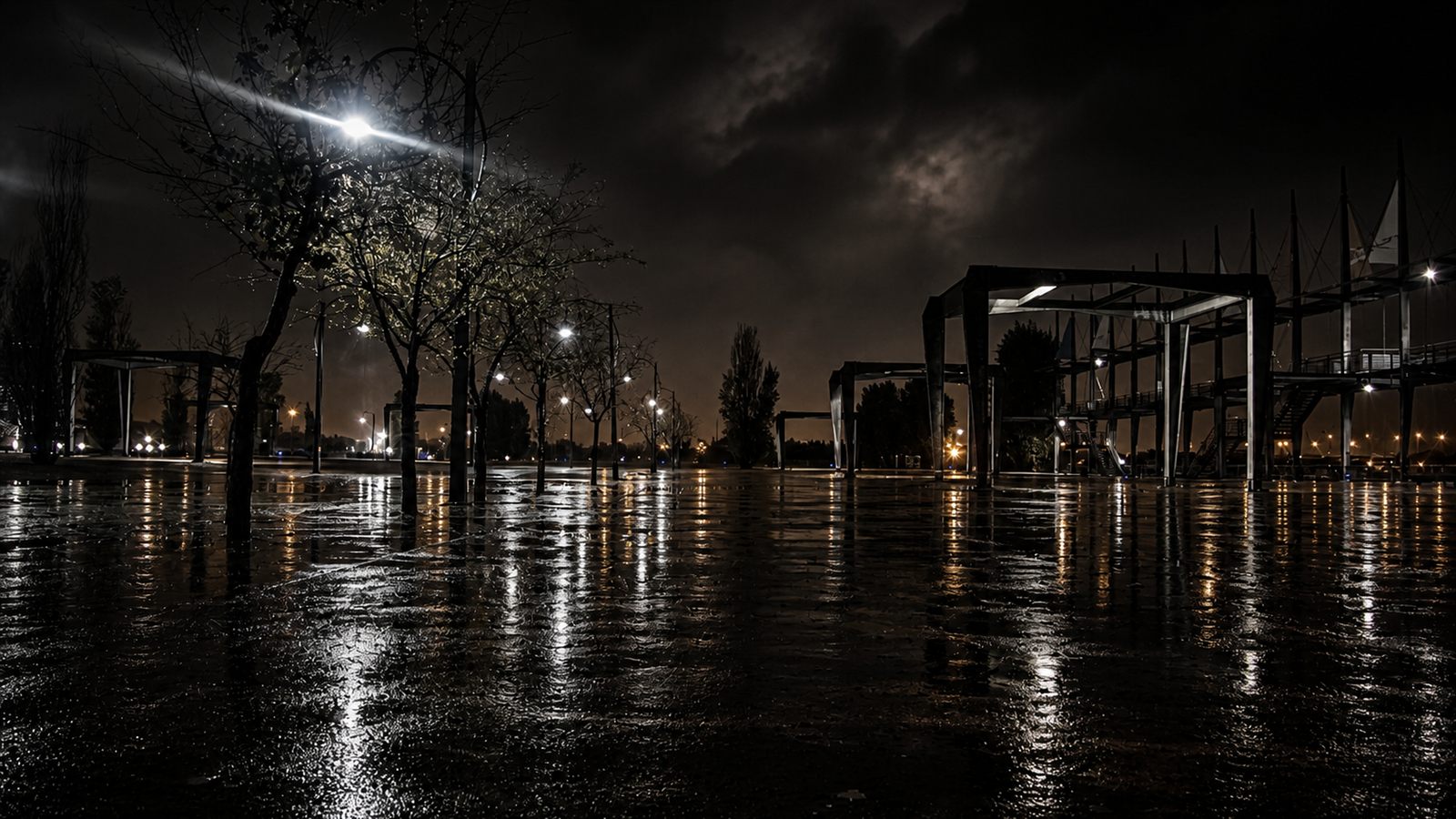 Urban Noir — Rain Reflections, wet pavement and amber streetlight at night
